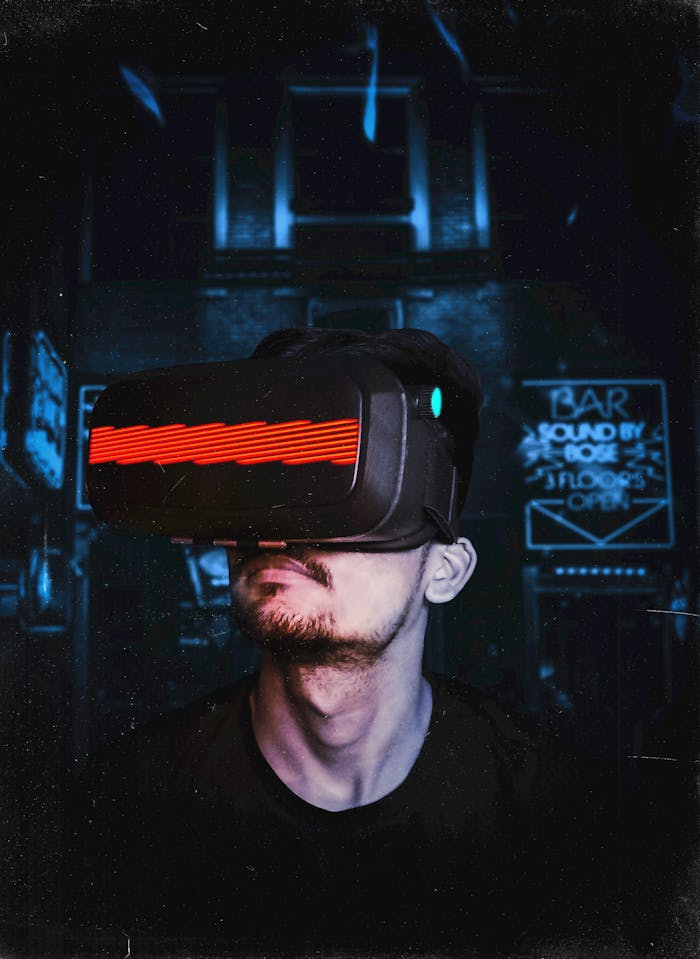 Services Young man immersed in a virtual reality experience using a VR headset, showcasing futuristic tech in a gaming environment.